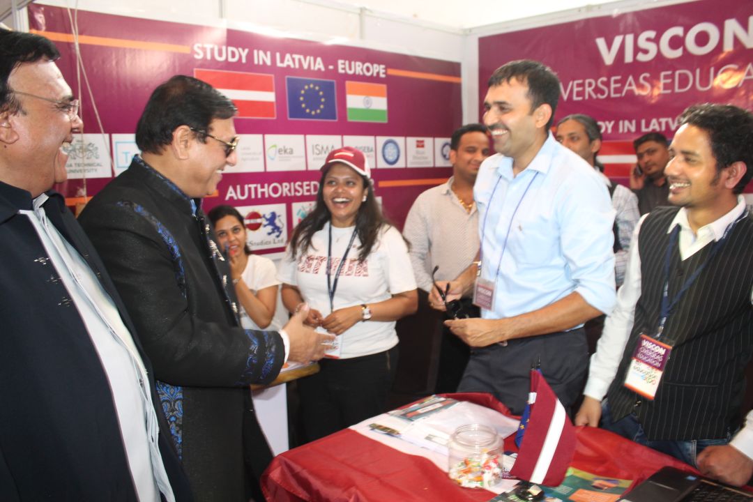 Nikunj Pandya at VisCon education fair booth meeting with industry leaders