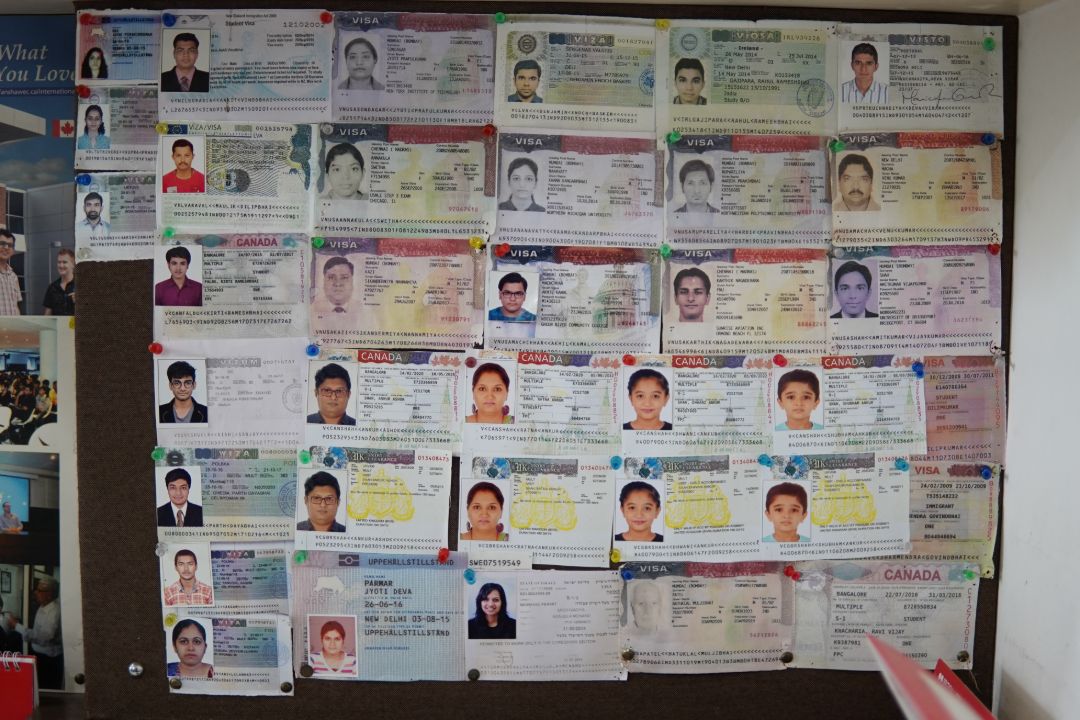 Wall of approved student visas at VisCon office